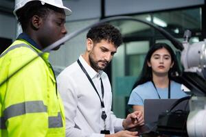 Technicians are introducing industrial hand robots to businessperson of factory industry who will use them in large-scale complex manufacturing operations. photo