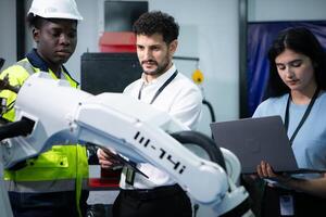 Technicians are introducing industrial hand robots to businessperson of factory industry who will use them in large-scale complex manufacturing operations. photo