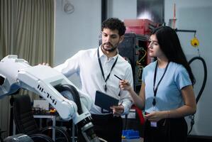 Businessperson of factory industry inspection and testing of robots arm for use in large-scale complex manufacturing industries. photo