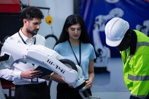 Technicians are introducing industrial hand robots to businessperson of factory industry who will use them in large-scale complex manufacturing operations. photo