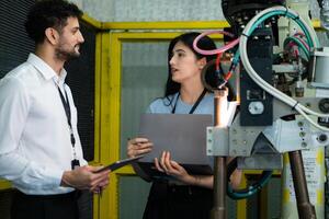 Businessperson of factory industry inspection and testing of robots arm for use in large-scale complex manufacturing industries. photo