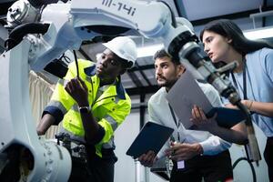 Technicians are introducing industrial hand robots to businessperson of factory industry who will use them in large-scale complex manufacturing operations. photo