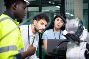 Technicians are introducing industrial hand robots to businessperson of factory industry who will use them in large-scale complex manufacturing operations. photo