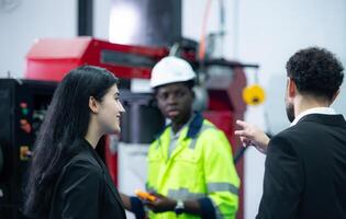 Technicians are introducing industrial hand robots to businessperson of factory industry who will use them in large-scale complex manufacturing operations. photo