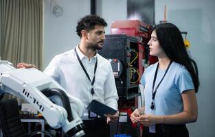 Businessperson of factory industry inspection and testing of robots arm for use in large-scale complex manufacturing industries. photo