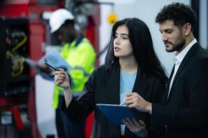 Portrait of businessperson of factory industry inspection and testing of robots arm for use in large-scale complex manufacturing industries. photo