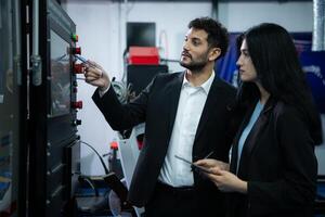 Businessperson of factory industry inspection and testing of robots arm for use in large-scale complex manufacturing industries. photo