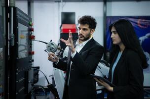 Businessperson of factory industry inspection and testing of robots arm for use in large-scale complex manufacturing industries. photo