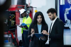 Portrait of businessperson of factory industry inspection and testing of robots arm for use in large-scale complex manufacturing industries. photo