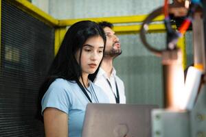 Businessperson of factory industry inspection and testing of robots arm for use in large-scale complex manufacturing industries. photo