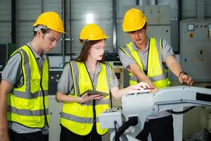 Engineer and technician discussing the robotic arm in factory about work operating, maintenance and repair photo