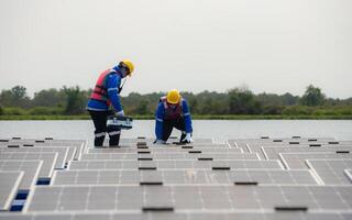 Photovoltaic engineers work on floating photovoltaics. Inspect and repair the solar panel equipment floating on the water. photo