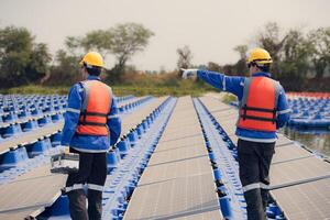 fotovoltaica ingenieros trabajo en flotante fotovoltaica. inspeccionar y reparar el solar panel equipo flotante en el agua. foto