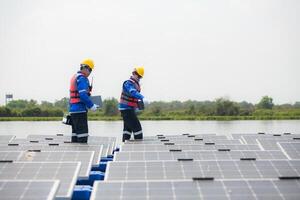 Photovoltaic engineers work on floating photovoltaics. Inspect and repair the solar panel equipment floating on the water. photo