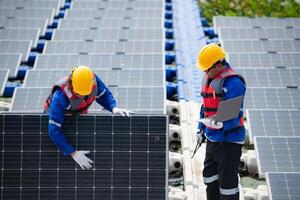 Photovoltaic engineers work on floating photovoltaics. Inspect and repair the solar panel equipment floating on the water. photo