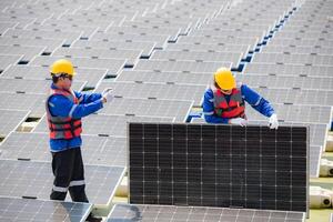 Photovoltaic engineers work on floating photovoltaics. Inspect and repair the solar panel equipment floating on the water. photo