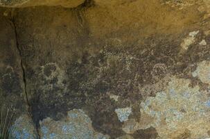 Ancient figures on the the stone photo