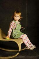 girl plays on the armchair photo