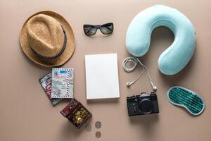 Packed suitcase of vacation items on wooden table, top view photo