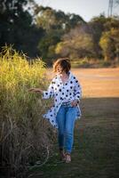 Fashion shot of a beautiful boho style girl on nature background. Boho, hippie. photo