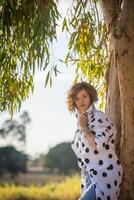 Fashion shot of a beautiful boho style girl on nature background. Boho, hippie. photo