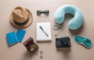 Packed suitcase of vacation items on wooden table, top view photo