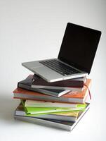 Stack of book and laptop photo