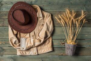 Wheat Ears on the Wooden Table. Sheaf of Wheat over Wood Background. Harvest concept. photo