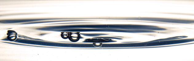 The round transparent drop of water, falls downwards photo