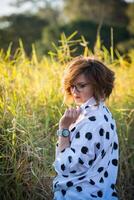 Fashion shot of a beautiful boho style girl on nature background. Boho, hippie. photo