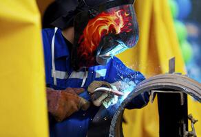 Welder working on metal welding photo