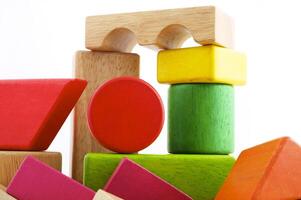 Wooden toy blocks on white background photo