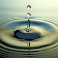 The round transparent drop of water, falls downwards photo