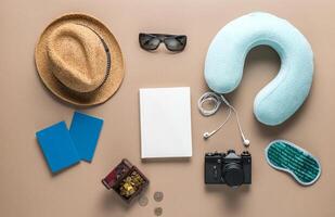 Packed suitcase of vacation items on wooden table, top view photo