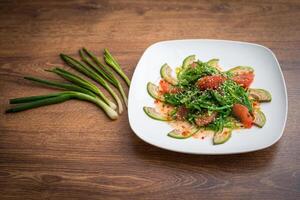 Vegetables Healthy Salad avocado, laminaria and grapefruit. photo