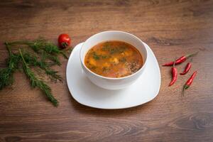 Traditional Kazakh kitchen-soup Shorpa with lamb. Soup on wooden table. photo