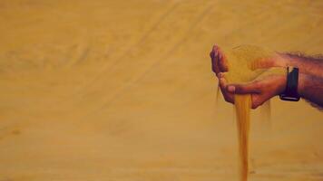 sand slipping from man's hand slow motion video