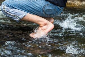 Feet relaxing in natural waterfall photo