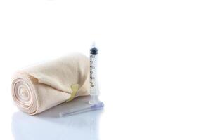 Elastic bandage roll and Medical syringes photo