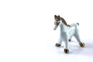 white ceramic figurine of a horse photo