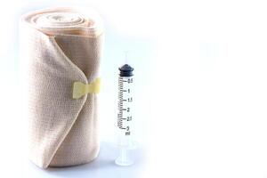 Elastic bandage roll and Medical syringes photo