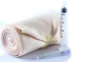 Elastic bandage roll and Medical syringes photo