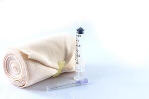 Elastic bandage roll and Medical syringes photo