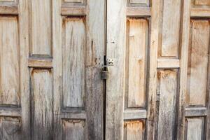 Old weathered wooden door made from planks. photo