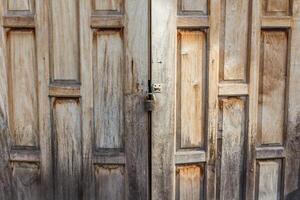 Old weathered wooden door made from planks. photo