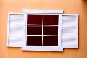 Vintage window on yellow cement photo