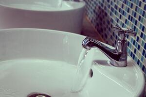Water tap with flowing water photo
