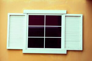 Vintage window on yellow cement photo