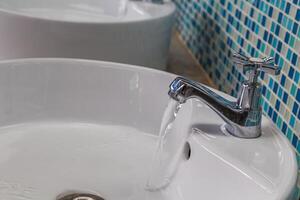 Water tap with flowing water photo