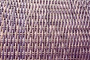 Synthetic rattan texture weaving background as used on outdoor photo